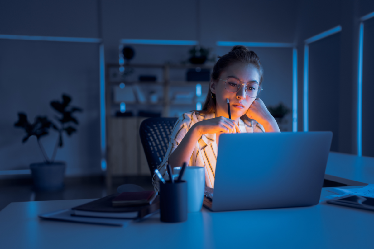 Kvinde der kigger på computer om aften med blue light briller